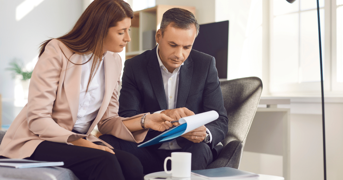Two people looking at a paper